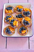 Mini tartlets with blueberry mascarpone cream, fruit and honey