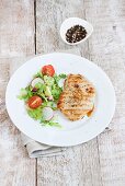 Grilled turkey breast with Hollandaise sauce and a side salad