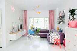 Living area in pastel shades with white wooden floor