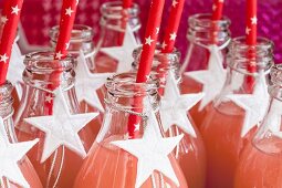 Fruit juice in glass bottles decorated with white stars