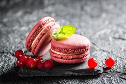 Redcurrant macaroons on a black stone