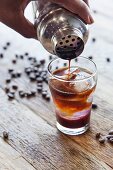 An espresso cocktail with berry syrup and lemonade
