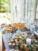 An Easter buffet laid on a wooden table by a window