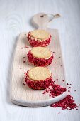 Strawberry shortcake ice cream sandwiches on a chopping board