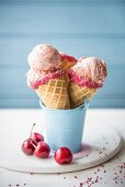 Cherry ice cream in cones with fresh cherries