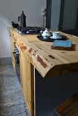 Gas hob on solid wooden live-edge kitchen counter