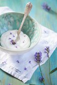 Coconut cream with lavender flowers in a ceramic bowl