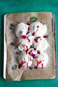 Classic meringues with blueberries and raspberry sauce