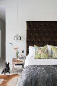 Furs and silver bedside table in contemporary bedroom