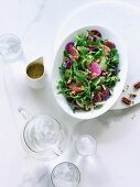 Fresh rocket salad with pecan nuts and watermelon radishes