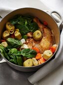 Chicken stew with artichokes, spinach and carrots