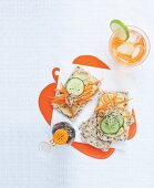 Crispbread topped with houmous, cucumber, carrots and bean sprouts