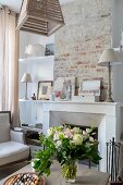 Open fireplace and rustic brick wall in living area of renovated townhouse