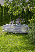 Table festively set in blue and white in summer garden