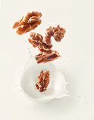 Walnuts falling into walnut milk