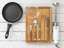 Kitchen utensils: a pan, cutlery, a knife and a hand blender