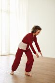 Looking from the sea to the sky (qigong) – Step 4: bend forward, cross hands in front of knee