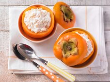 Yoghurt and honey muesli served in persimmons