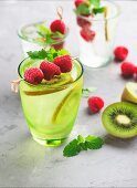 Ice cold summer lemonade with raspberries and kiwi