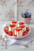 Lime and yogurt puddings with strawberry sauce
