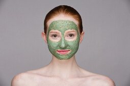 A young woman with a green face mask