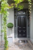 Restored, traditional entrance area with ornamental tiles and pillared support