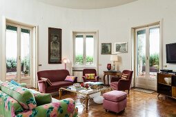 Mixture of antique furniture in living room with rounded wall