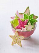 A bowl of colourful Christmas star biscuits