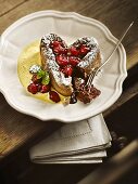 A heart-shaped chocolate cake with sour cherries on vanilla sauce