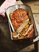 Crispy shoulder of suckling pig on a bed of oven-roasted vegetables