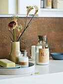 Bathroom accessories arranged on a washstand with flowers