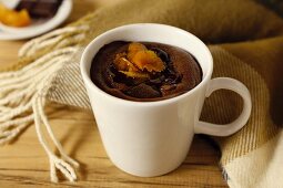 Warm chocolate dessert with dried fruit in a cup