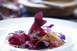 Beetroot with onion, truffle and edible flowers