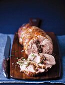 Slices of rolled pork neck stuffed with prunes and rosemary