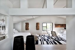 Lounge area and black and white rug in attic bedroom