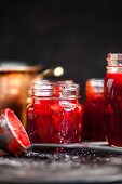 Strawberry jam being filled into jars