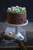 An Easter cake decorated with a chocolate glaze and sugar eggs