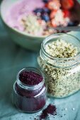Superfood ingredients: Hemp and acai powder in glass jars