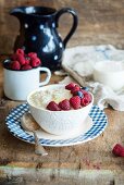 Kascha (Russian rice porridge) with butter, raspberries blueberries and milk