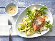 Frisee lettuce and melon salad with pan-fried pike-perch fillet