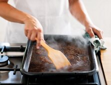 Gravy being reduced in a baking tray