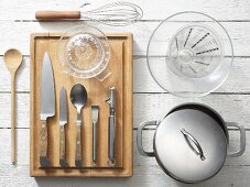 Kitchen utensils for preparing orange couscous with vegetable salad