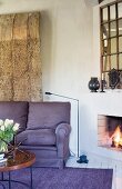 Open fire, mirror and wooden sculpture in lounge area