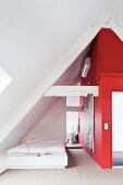 Schlafzimmer mit roter Wand im Dachgeschoss