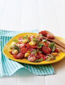 Mixed tomato salad with red onion and basil