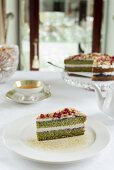 Spinach and pistachio sponge cake with pomegranate seeds and berry mousse