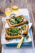 Puff pastry tarts with courgette, caramelised onion and rocket