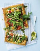 Puff pastry tart with green asparagus, ricotta, cherry tomatoes, bacon and rocket