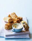 Filo pastry rolls with green asparagus, ham and Camembert