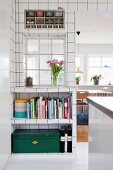White wall tiles, interior window and open-fronted fitted shelves in kitchen